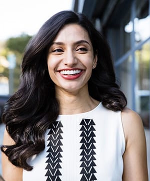 An adult holding an Invisalign clear aligner